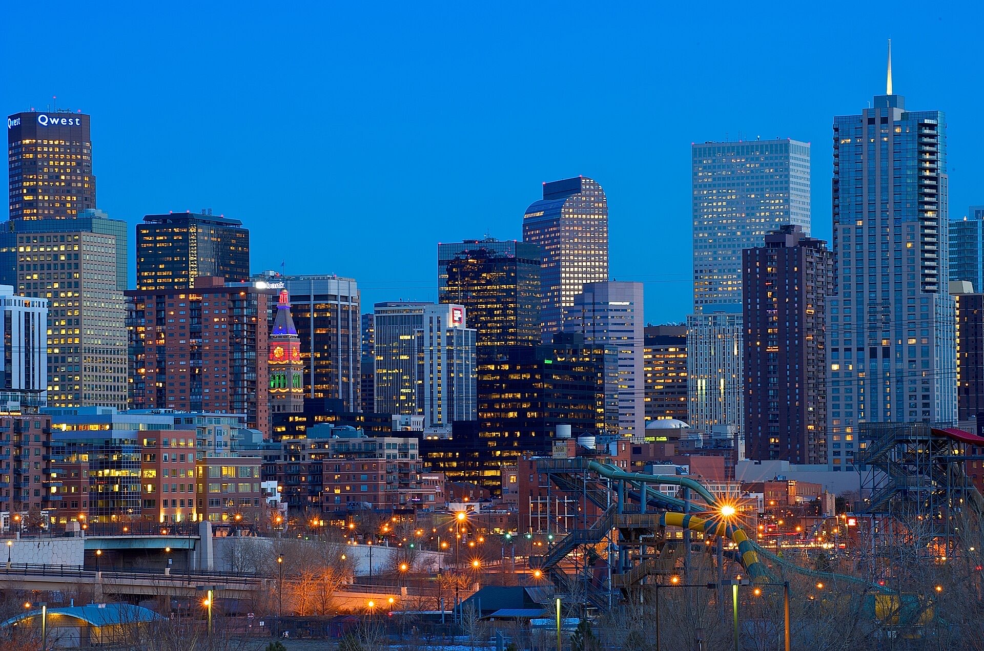 Downtown Denver high-rises lit up at dusk
