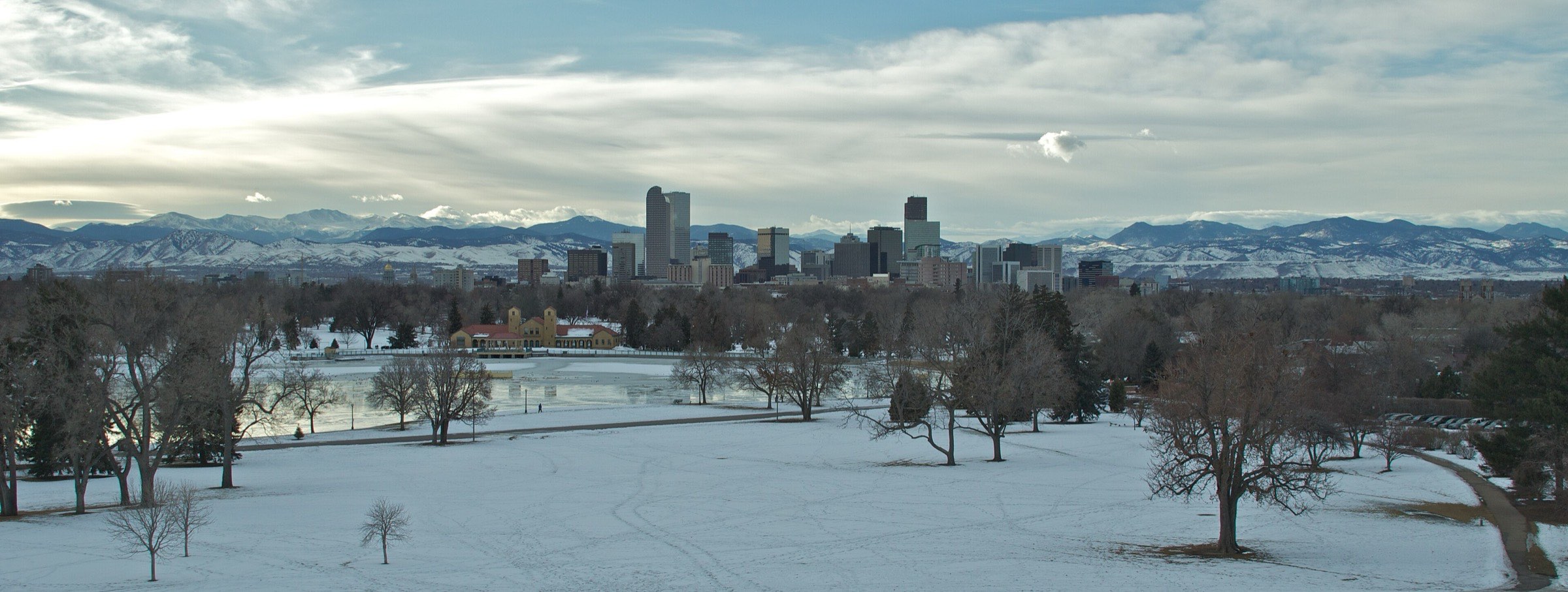 Snow-covered City Park in Denver with the skyline and the Front Range behind it