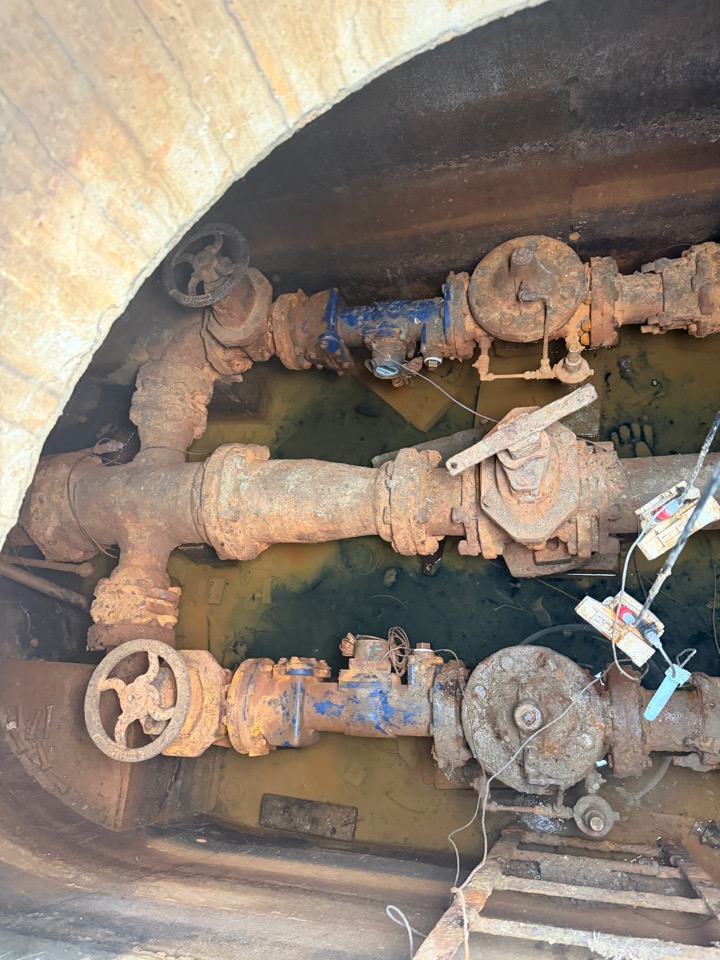 Two large backflow assemblies side by side in a water vault