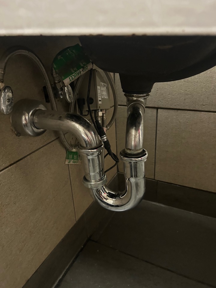 The same chrome drain reassembled after the repair