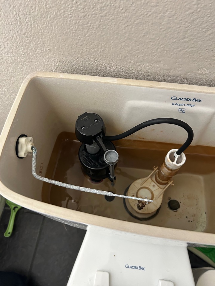 A toilet tank with a new fill valve installed