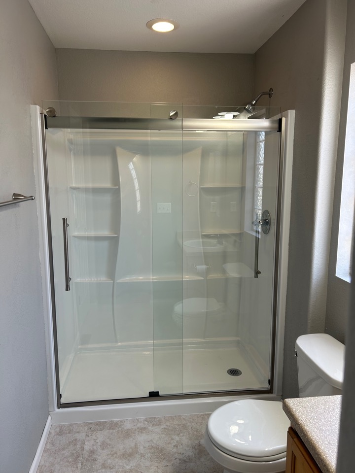 The finished shower with a sliding glass door, where the tub used to be