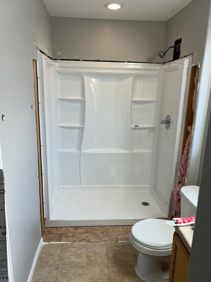 A new shower base and wall panels installed where the tub was