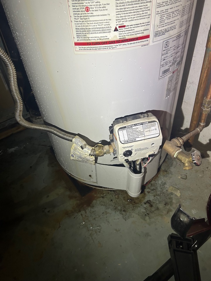 Rust and corrosion around the gas valve and base of an old water heater